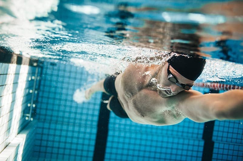 Man swimming, under water shot.